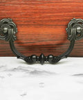 Two Tone Antique Bronze And Black Vintage Drawer Pulls With 4.25 Inch Hole Pitch in Zinc Alloy, front view on a wooden surface