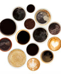 Top view of various coffee cups and frothy latte art from an Automatic Espresso Machine With Auto Clean And LatteGo Milk System.