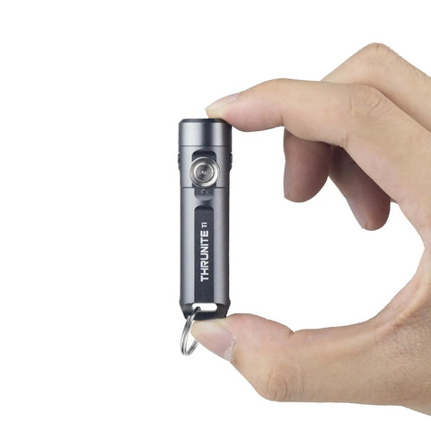 Hand holding Ti2 EDC Flashlight Tiny But Mighty Pocket Size Keychain Light With 120 Lumen Output Powered By AAA Battery Ultra Lightweight Waterproof And Shockproof For Everyday Carry Black