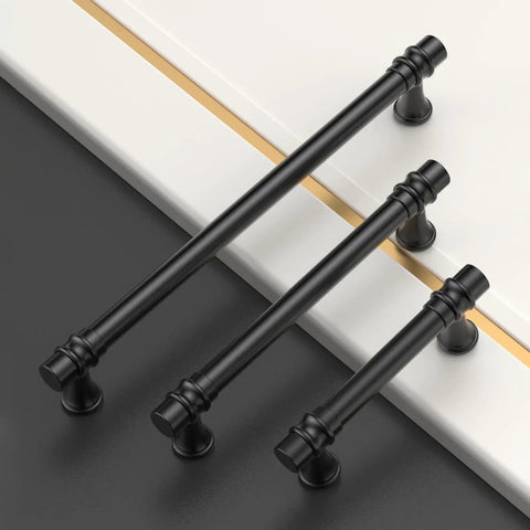 10 Pack 5 Inch Matte Black Cabinet Pulls Kitchen Drawer Handles on surfaces, showing varying sizes and sleek design.