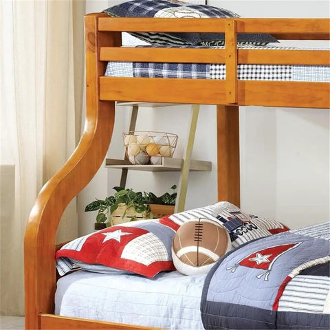 Twin Over Full Bunk Bed With Upper Rails Angled Ladder And Bold Curved Wood Design In Oak Finish Ideal For Kids Rooms And Sleepovers A Space Saving Loft Bed For Playtime And Slumber image showing wooden side rail and bedding.