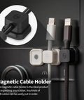 Close-up of black Magnetic Cable Clips 3 Pack For Car And Office Cable Management on a black dashboard holding cables.