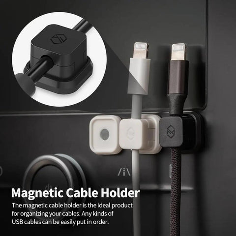 Close-up of black Magnetic Cable Clips 3 Pack For Car And Office Cable Management on a black dashboard holding cables.