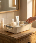 Heavy Duty Plastic Storage Bins With Open Top Design For Zero Stress Home Organization on wooden cabinet with toiletries.