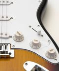 Close-up of electric guitar control plate with Metal Guitar Knob Position Markers 10 Piece Dope Set Indicator Plates for tone and volume control.