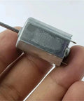 Tiny 18mm Square DC Motor 12V 18V 24V Micro 6 Pole Rotor Electric Motor For Industrial Use, held between fingers.