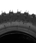 Close-up of Set Of 2 145/70-6 Tubed Knobby Tires With Inner Tubes For Mini Bikes Quad Go Karts ATVs UTVs Golf Carts Lawn Mowers And More 6 Inch Rim Size With Valve Caps Included showing tire tread and size marking.