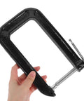 Hand holding Heavy Duty Universal Three Inch Tabletop Mounting Clamp For Woodworking And Desk Fixtures With 180mm Jaw Opening