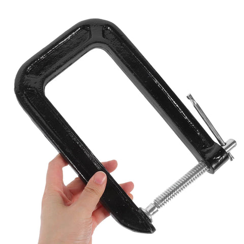 Hand holding Heavy Duty Universal Three Inch Tabletop Mounting Clamp For Woodworking And Desk Fixtures With 180mm Jaw Opening