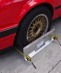 Heavy Duty 2 Wheel Alignment Tool For Camber Caster And Toe With Knockout Precision Wheel Standoffs beside red car wheel.