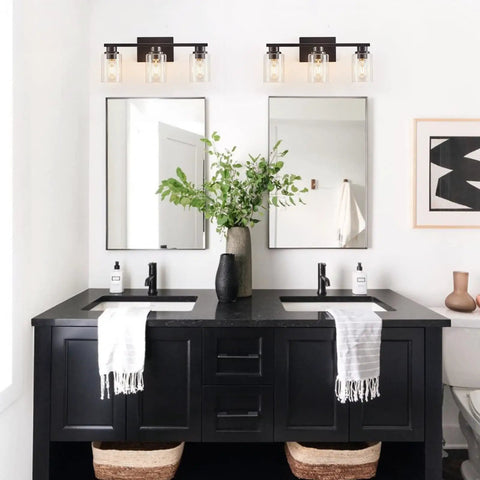 Dual Sleek Matte Black 3 Light Vanity Lights with Clear Glass Shades in modern bathroom setting.