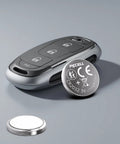 Top Shelf CR2032 Lithium 3V Coin Cell Batteries 20 Pack next to a modern car key fob on a gray background.