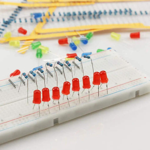 Arduino Project Essentials Kit With 600 Resistors From 10 Ohm To 1 MOhm Across 30 Values And 200 5mm LEDs In 5 Colors For Quick Circuit Testing And Prototyping No Solder Required shown on a breadboard with red LEDs and resistors.