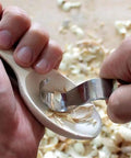 Kickass Stainless Steel Spoon Carving Knife And Hand Chisel Tools With Slick Ergonomic Grip carving a wooden spoon.