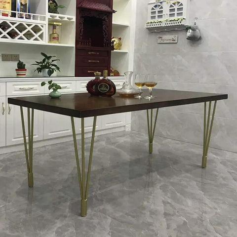 Heavy Duty 28 Inch Gold Hairpin Table Legs With Adjustable Leveling Bolts For Modern Dining And Coffee Tables support a wooden table.