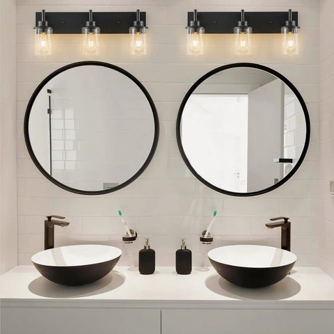 Two Light Black Industrial Vanity Light Sconces With Clear Glass Shades over black and white bathroom sinks