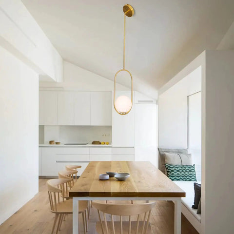 Gold Globe Pendant Light Fixture With Adjustable Hanging Length, Modern Mid Century Chandelier in a dining room setting.