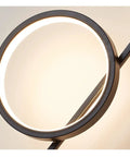 Top Shelf Modern Wall Sconce With Straight Fire Led Glow And Hella Sturdy Iron Frame close-up of circular design with LED light.