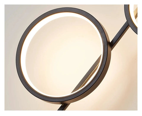 Top Shelf Modern Wall Sconce With Straight Fire Led Glow And Hella Sturdy Iron Frame close-up of circular design with LED light.