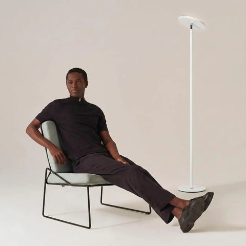 Sky LED Floor Lamp Torchiere Lit And Super Bright Dimmable Tall Standing Lamp for Living Room Decor beside modern armchair.