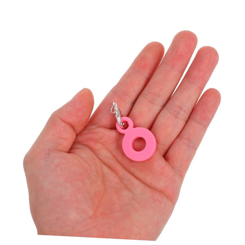 Hand holding a pink charm from Six Pack Silicone Straw Charm Adapters For Tumblers, Stylish And Fun Straw Pendants For Home Parties Cafes And Gatherings