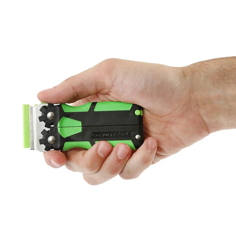 Hand holding green and black tool from 11 Piece Multi Purpose Razor Blade Scraper Kit With 10 Blades For Window Glass Sticker Removal And Flat Edge