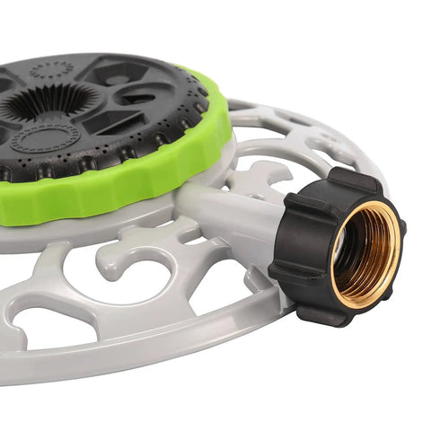 Close-up of 8 Pattern Turret Sprinkler with adjustable spray heads on durable metal base for lawn and garden watering.