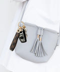 Dope And Totally Legit Premium Leather Wristlet Keychain Featuring Sparkling Crystal Diamonds And Classy Craft Pearls for keys attached to a gray purse.