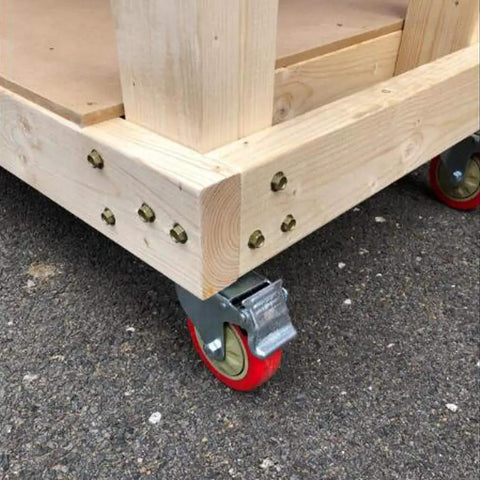 Heavy Duty Swivel Furniture Casters Four Piece Set Five Inch Polyurethane Treads mounted on a wooden cart with red wheels.