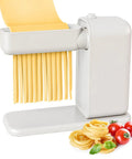 Electric Pasta Maker With Roller And Cutters For Fresh Noodles, white machine producing fresh fettuccine, with tomatoes and pasta nearby.