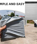 Hand holding a gray Waterproof Self Sealing PE Shipping Bag For Clothing And Shoes, 100 Pack Durable Mailer Envelopes