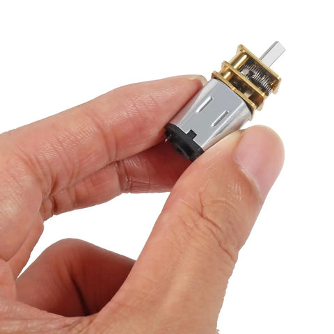 Hand holding Tiny All-Metal 12V 30RPM Gear Motor With Gearbox For DIY RC Toys And Smart Cars, N20 Reduction, Mini Micro Gearhead