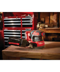 V20 Cordless 5 Inch Orbital Sander Bare Tool With 12,000 OPM on workbench, showing low-profile design and onboard dust bag.