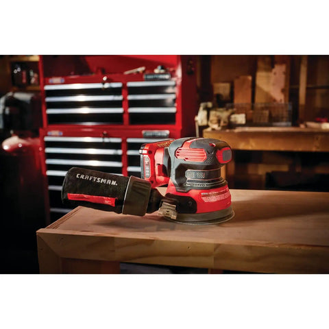 V20 Cordless 5 Inch Orbital Sander Bare Tool With 12,000 OPM on workbench, showing low-profile design and onboard dust bag.