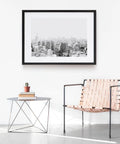 Peel And Stick Molding And Wall Trim Set For DIY Home Decor On Cabinets Doors Mirrors And Frames Self Adhesive No Mess Easy Install Non Toxic 16.4 Ft Long By 0.8 In Wide in a minimalistic room with a cityscape frame, woven chair, and table.