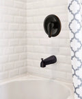 Middleton II Transitional Single Handle Shower Valve Trim with Escutcheon in oil rubbed bronze on white tiled wall above bathtub