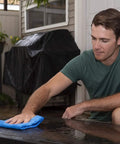 Blue Absorber drying cloth on outdoor glass table; large synthetic car-drying cloth