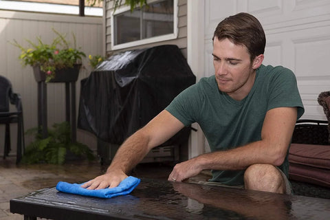Blue Absorber drying cloth on outdoor glass table; large synthetic car-drying cloth