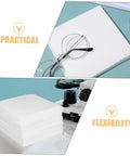 Heavy Duty 600 Count Dustless Lab Wipes For Camera Lenses And Precision Gear Oil Absorbent Cleanroom Cleaning Pads stacked with glasses and microscope.
