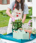 Person using Metal Garden Tool Organizer Caddy With Four Compartments And Wooden Handle For Indoor And Outdoor Use