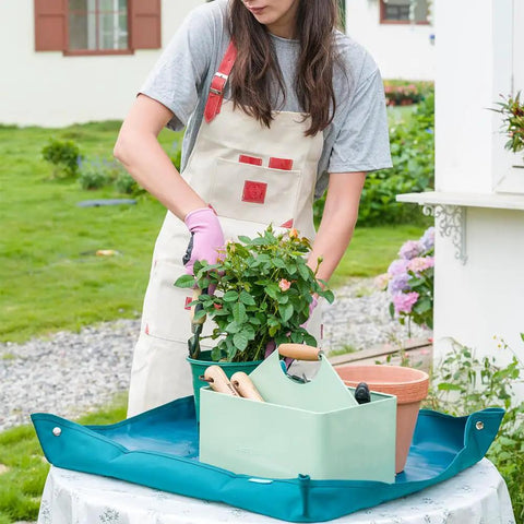 Person using Metal Garden Tool Organizer Caddy With Four Compartments And Wooden Handle For Indoor And Outdoor Use