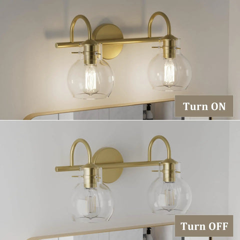Two-Light Gold Bathroom Vanity Light Fixture With Clear Globe Shades, Modern Brushed Gold Wall Sconce For Over Mirror, E26 Base Vanity Lighting, Dope Home Bath Decor shown turned on and off.