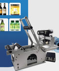 Bulletproof Workhorse Semi Automatic Round Bottle Labeling Machine With Onboard Code Printer And Date Stamper For Clear Wrap Labels, side view with various containers.