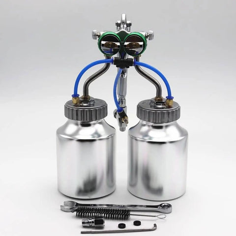Pro Grade Pressure Feed Spray Gun With Dual Nozzles For Silky Smooth Coatings and Crisp Edge Lines features two silver pots and tools.