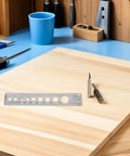 Heavy Duty Stainless Steel Pneumatic Lockout Clamp For Hoses Quick Disconnect Safety Device on a wooden workbench with tools.