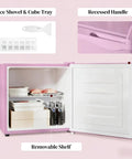 Inside view of Slick Compact Upright Freezer Featuring Adjustable Temperature Settings Removable Shelf Reversible Door For Tight Kitchens Hella Tough Steel Frame With Fun Ice Cube Making Gear For Busy Households showing ice shovel, cube tray, and removable shelf.