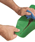 Flexible Shapeable Funnel For Any Job, Reusable Silicone Pouring Tool being wiped clean while flattened, showing green material.