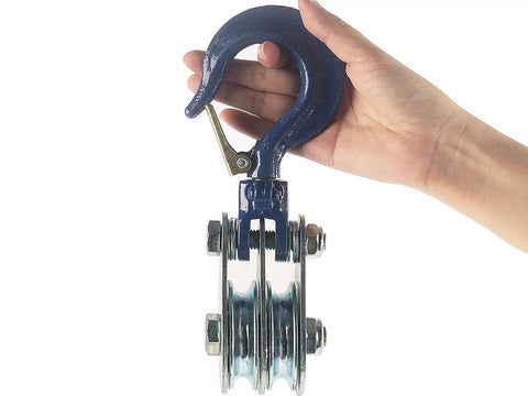 1 Ton Double Pulley Snatch Block With Hook Heavy Duty Wire Rope Lifting Pulley For Traction Trucks And Trolleys Safe Anti Disengagement Design Galvanized Steel Construction Bearings Built In close-up in hand