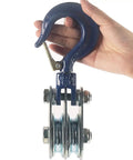 Badass Heavy Duty Double Pulley Snatch Block With Hook 1 Ton Load Rating held by hand, showcasing galvanized steel design and dual wheels.