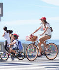 Cyclists on a sunny day with colorful bike spoke beads on wheels, showcasing Colorful Bike Spoke Beads Kit For Kids in action.